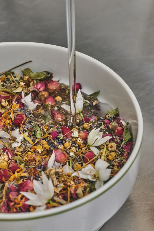 Botanical infusion jars steeping in the dark — the Ancient Amber™ steep at Ancient Nature