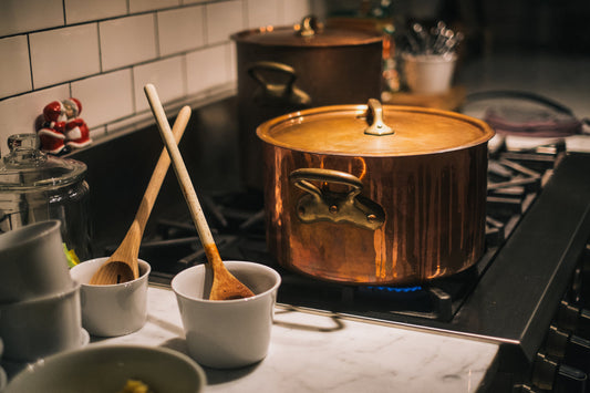 Bison suet rendering gently in a stainless steel pot — in-house tallow rendering at Ancient Nature
